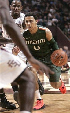 Miami's Shane Larkin looks for an opening in the Florida State defense in the first half of an NCAA college basketball game Wednesday, Feb. 13, 2013,...