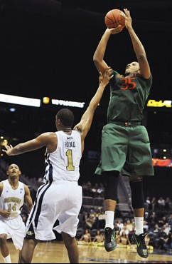 Miami center Kenny Kadji shoots over Georgia Tech forward Julian Royal. Kadji contributed 21 points as Miami won 64-49. (AP Photo/Gregory Smith)