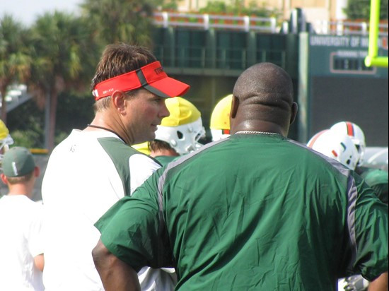 Head Coach Al Golden shares a word with former Hurricane Warren Sapp during Friday's practice.
