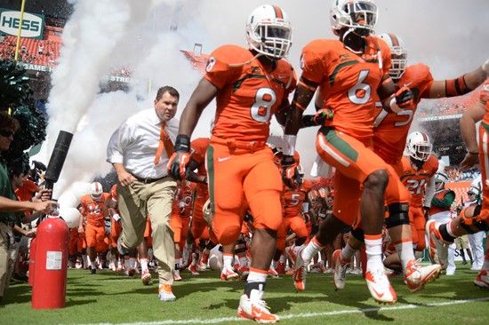 University of Miami Hurricanes head coach Al Golden leads his team on the field in a game against the Wake Forest Demon Deacons at Sun Life Stadium on...