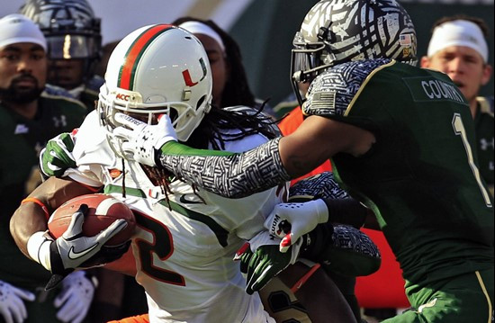 Jerrell Young grabs  LaRon Byrd (2) by the face mask. (AP Photo/Chris O'Meara)