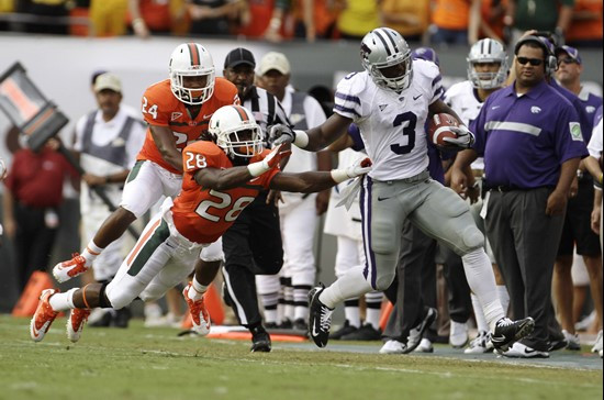 Kansas State's Chris Harper (3) outruns Miami players Davon Johnson (24) and Andrew Swasey (28) for a short gain. (AP Photo/J Pat Carter)