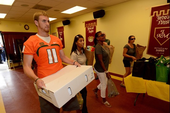 Ryan Williams carries one of the turkey boxes Tuesday.