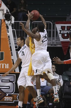 Miami's Trey McKinney Jones (4) and Garrius Adams (25) block Valparaiso's Erik Buggs (15) during the second half. (AP Photo/J Pat Carter)
