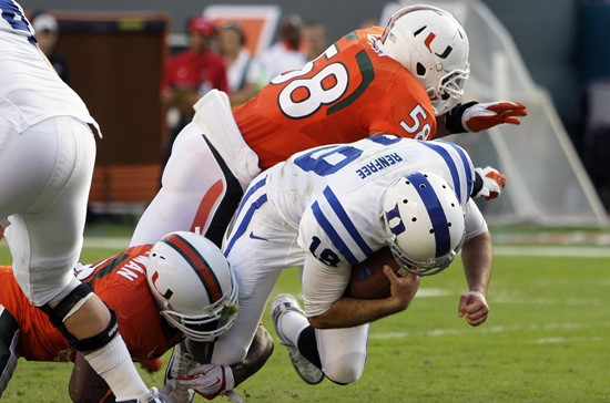 Miami linebacker Jordan Futch (58) tries to bring down Duke quarterback Sean Renfree. (AP Photo/Lynne Sladky)