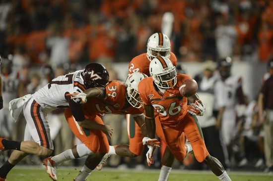  University of Miami Hurricanes defensive back Antonio Crawford #39 and Herb Waters #86 scramble to recover the ball after a blocked punt in a game...