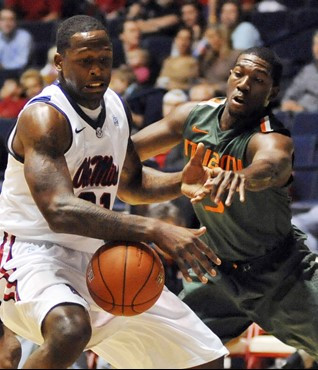 Mississippi's Murphy Holloway (31) has the ball knocked away by Miami's Malcolm Grant (3) during an NCAA college basketball game in Oxford, Miss. on...