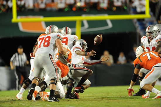 University of Miami Hurricanes defensive lineman Darius Smith #98 forces a fumble in a game against the Ohio State Buckeyes at Sun Life Stadium on...