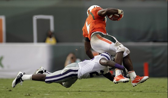 Kansas State's David Garrett (27) stops Miami's Lamar Miller (6). (AP Photo/J Pat Carter)
