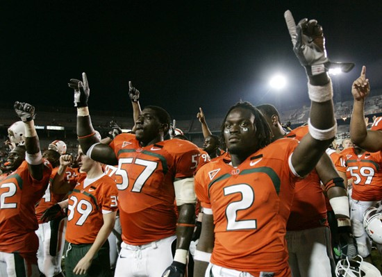 Miami running back Graig Cooper (2) react to Miami's school song with Allen Bailey (57) after Miami beat Texas A&M, 34-17 Thursday. (AP Photo/Lynne...