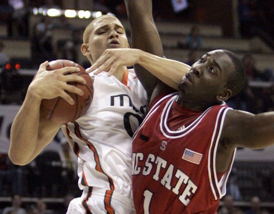 Jimmy Graham and North Carolina State's J.J. Hickson battle for a rebound in the second half. (AP Photo/Gerry Broome)