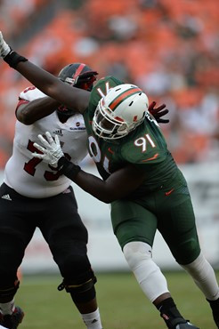 University of Miami Hurricanes defensive lineman Olsen Pierre #91 plays in a game against the Arkansas State Red Wolves at Sun Life Stadium on...