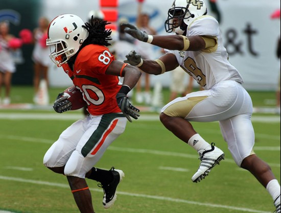 Travis Benjamin scores a touchdown as Joe Burnett defends during first quarter.