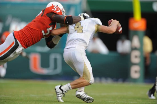 University of Miami Hurricanes defensive lineman Allen Bailey #57 tackles the quarterback in a game against the University of Central Florida Knights...