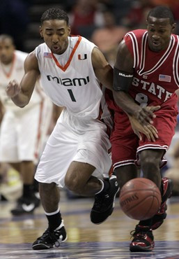 Lance Hurdle and North Carolina State's Courtney Fells battle for a loose ball during the first half of an ACC men's basketball tournament game at...