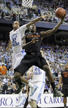 Miami's Durand Scott (1) drives past North Carolina's John Henson (31) in the second half of an NCAA college basketball game at the Atlantic Coast...