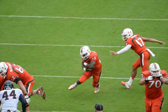 University of Miami Hurricanes running back Dallas Crawford #25 plays in a game against the Virginia Cavaliers at Sun Life Stadium on November 23,...