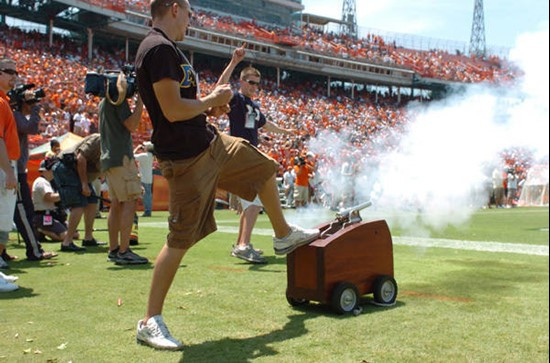 University of Miami fraternity Epsilon Chi students fire a cannon after the Hurricanes score in a game against marshall University at the Orange Bowl...