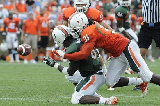 Sean Spence puts a hit on Lamar Miller at the 2011 Miami Hurricanes Spring Football Game @ Lockhart Stadium