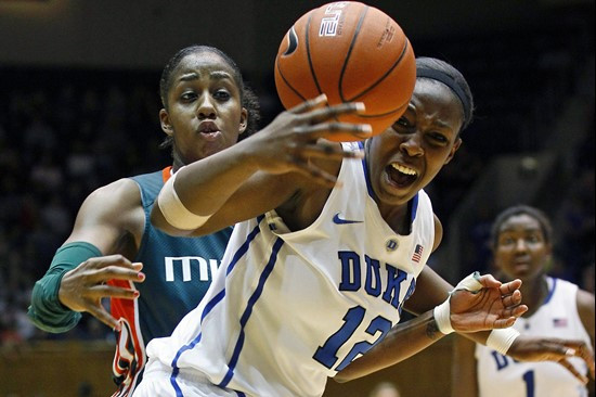 Duke's Chelsea Gray (12) and Miami's Shenise Johnson reach for the ball during the second half. (AP Photo/Gerry Broome)