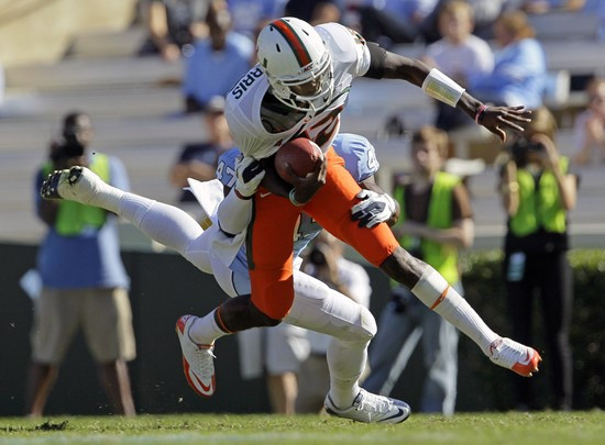Miami quarterback Jacory Harris is upended by North Carolina's Zach Brown (47). (AP Photo/Gerry Broome)