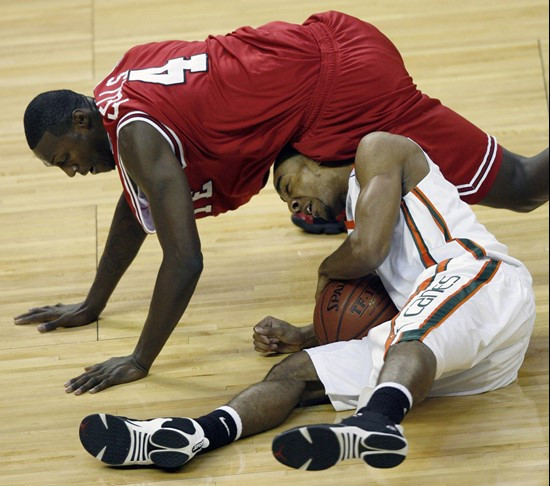 Lance Hurdle beats North Carolina State's Courtney Fells to a loose ball in the first half. (AP Photo/Rick Havner)