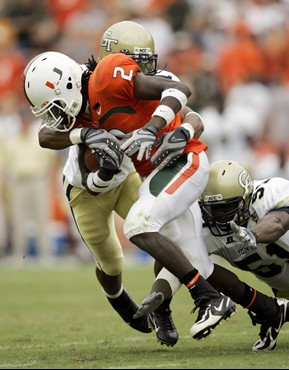 Miami running back Graig Cooper (2) is taken down by Georgia Tech safety Morgan Burnett, rear, and linebacker Brad Jefferson, right, during the second...