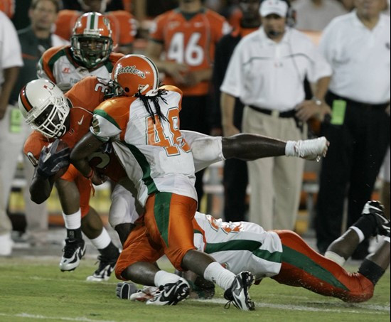 Miami runningback Tyrone Moss is taken down by Florida A&M outside linebacker Victoriano Arboleda (48) during the third quarter Saturday, Sept. 9,...