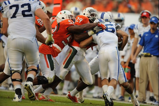 University of Miami Hurricanes defensive back JoJo Nicolas #29 and linebacker Denzel Perryman #52 make a tackle in a game against the Duke Blue Devils...