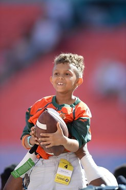 University of Miami Hurricane fan Carter Huck had his dream come true as he got to walk through a tunnel of smoke with Sebastian the Ibis and the...