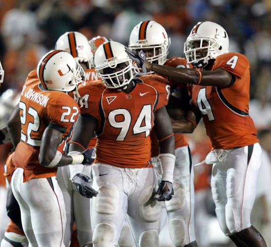 Miami defensive end Eric Moncur (94) is congratulated by teammates after he recovered a fumble by Florida A&M running back Arsenio Ivory (not shown)...