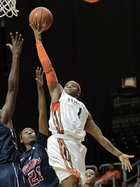 Miami's Riquna Williams (1) goes to the basket as Ole Miss' Danielle McCray (21) defends in the first half. (AP Photo/Alan Diaz)