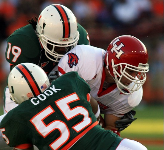 Houston's Mark Hafner is tackled by Miamis Glenn Cook (55) and Brandon Meriweather (19) after catching a pass in the first quarter. (AP Photo/Luis M....