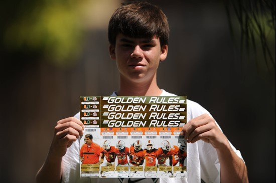 University of Miami Hurricane fan Matthew Murphy shows off his “GOLDEN RULES” tickets before the...