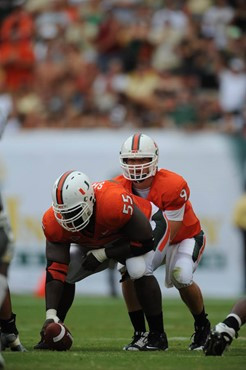 University of Miami Hurricanes quarterback Robert Marve #9 gets set to take a snap from center Xavier Shannon #55 in a game against the University of...
