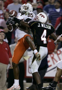 Maryland cornerback Josh Wilson, right, knocks a pass away from Miami wide receiver Ryan Moore, left, in the end zone during the second half of their...