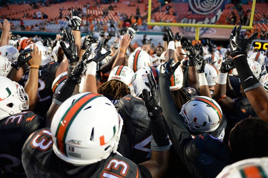 University of Miami Hurricane players meet in a sign of unity before a game against the Duke Blue Devils at Sun Life Stadium on September 27, 2014. ...