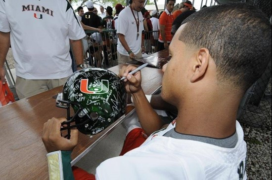 Stephen Morris signs a green UM helmet befor the 2011 Miami Hurricanes Spring Football Game @ Lockhart Stadium