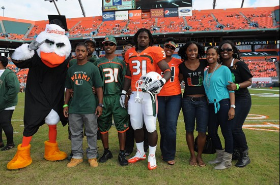 University of Miami linebacker Sean Spence #31 and his family pose for a picture before his final game with the Hurricanes.  The Canes played against...