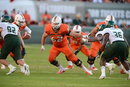 University of Miami Hurricanes offensive lineman Shane McDermott #62 plays in a game against the University of South Florida Bulls at Sun Life Stadium...