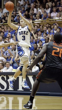 Duke's Greg Paulus (3) passes as Miami's Dwayne Collins (21) defends during the first half of a college basketball game in Durham, N.C., Saturday,...