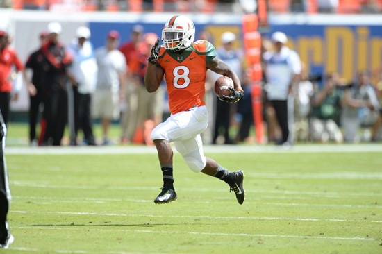 University of Miami Hurricanes running back Duke Johnson #8 scores a touchdown in a game against the Cincinnati Bearcats at Sun Life Stadium on...
