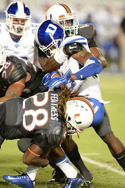 University of Miami Hurricanes make a gang tackle in a game against the Duke Blue Devils at Sun Life Stadium on September 27, 2014. Photo by Steven...