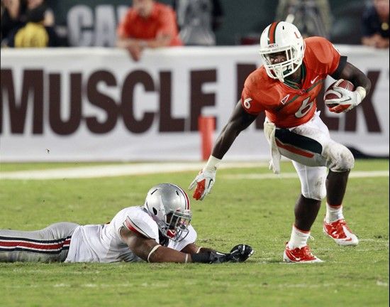 Miami running back Lamar Miller breaks away from Ohio State linebacker Etienne Sabino during the second quarter of an NCAA college football game,...
