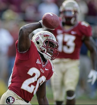 Florida State safety Lamarcus Joyner (20) spikes the ball after making an interception in the end zone during the first quarter of an NCAA college...