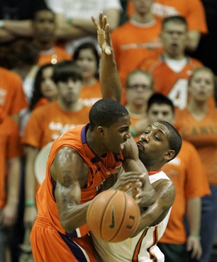 Clemson guard Demontez Stitt loses control of the ball as he drives against James Dews. (AP Photo/Wilfredo Lee)