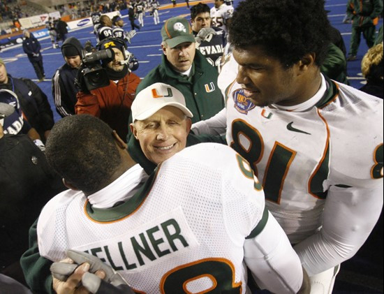 Miami coach Larry Coker is hugged by players after the Hurricanes' 21-20 win over Nevada in the MPC Computers Bowl. (AP Photo/Idaho Statesman, Darin...