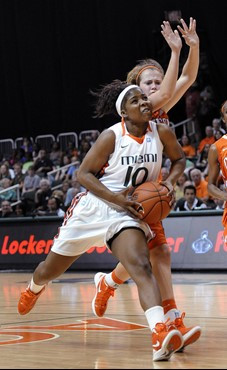 Miami's Michelle Woods, left, is defended by Clemson's Kelly Gramlich, right, during the first half of an NCAA college basketball game Sunday, Feb. 5,...