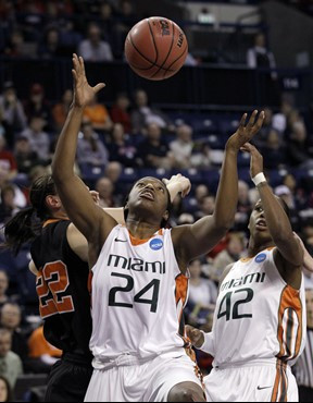 Miami's Jessica Capers (24) grabs a rebound in front of teammate Shenise Johnson (42) and Idaho State's Ashleigh Vella in the first half of an NCAA...