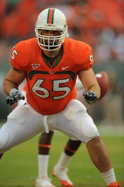 University of Miami Hurricanes offensive lineman Brandon Linder #65 gets set to block in a game against the Boston College Eagles at Sun Life Stadium...
